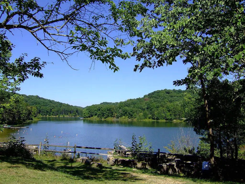 Lake surrounded by gentle rolling forested hills